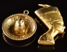 A 14k gold charm in the form a sombrero (2.2g) and an 18k gold pendant in the form of Nefertiti (