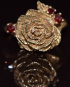 A 9ct gold ring the form of a rose set with garnets, 6.3g, size P