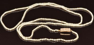 A single strand of natural pearls, the 9ct rose gold clasp set with split pearls, 90cm, 12g