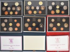 Six Royal Mint deluxe proof coin sets comprising 1984, 1985, 1986, 1987 and two 1989