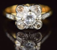 An 18ct gold ring set with a diamond of approximately 0.4ct and four smaller diamonds, in a platinum