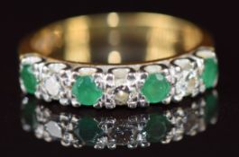 An 18ct gold ring set with round cut emeralds and diamonds, 4.2g, size O