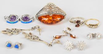 A 9ct gold ring set with paste (1.4g, size M), two silver rings one set with pressed amber, and