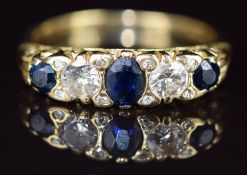 An 18ct gold ring set with three oval cut sapphires of approximately 0.3, 0.1 & 0.1ct,  two diamonds