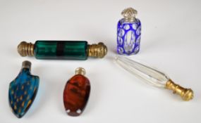 Five 19thC scent / perfume bottles including double ended, overlaid and cut, fluted design with gilt