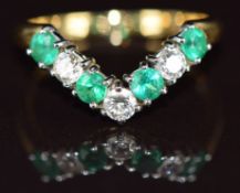 An 18k gold 'V' shaped ring set with alternating diamonds and emeralds, each approximately 0.15ct,