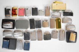 Over thirty Ronson cigarette lighters together with a box of genuine Ronson spare parts. PLEASE NOTE