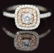 A 14ct gold ring set with diamonds, the largest approximately 0.29ct, surrounded by two rows of