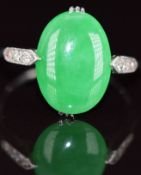 Art Deco platinum ring set with a jade cabochon and three diamonds to each shoulder, 4.2g, size O