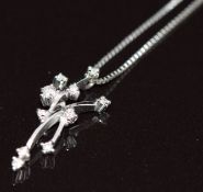 An 18k white gold pendant set with diamonds (0.7g) on platinum chain (2.2g)
