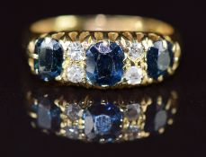 An 18ct gold ring set with sapphires and diamonds, Birmingham 1913, 4.6g, size K