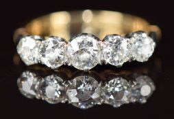 An 18ct gold ring set with five old cut diamonds, the centre diamond approximately 0.3ct, 3g, size