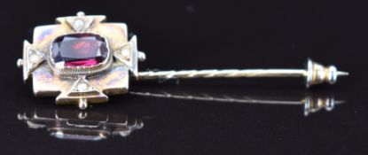 A 9ct gold stick pin set with a foiled garnet and seed pearls, 4g, 5.5cm