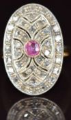 An 18k gold ring set with a round cut ruby and diamonds in an oval pierced setting, 6.5g, size R