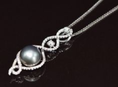 An 18k white gold pendant set with a Tahitian pearl (10.6mm) and diamonds in a twist setting, on 18k