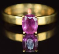 An 18ct gold ring set with an oval cut pink sapphire of approximately 0.8ct, 4.5g, size O