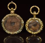 Two yellow metal Victorian mourning lockets with engine turned decoration and a locket compartment
