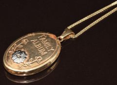 A 9ct gold locket engraved 'family album' verso 'held closest to the heart' (4cm) on 9ct gold chain,