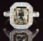 A 9ct gold ring set with an emerald cut zultanite of approximately 1.5ct surrounded by diamonds, 3.