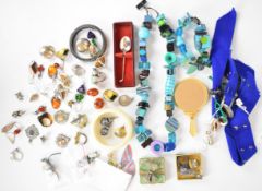 A collection of silver jewellery including six rings, ten pairs of earrings, four medallions and a