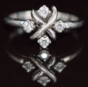 Tiffany & Co platinum ring set with four diamonds in a cross design, 5.1g, size O