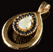 A 9ct and 18ct gold pendant set with a pear cut opal surrounded by sapphires, 7.3g, 3.5 x 2.2cm