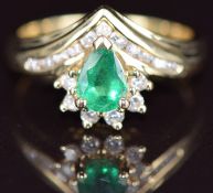 A 14k gold ring set with a pear cut emerald of approximately 0.4ct and diamonds, size M