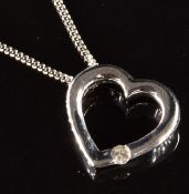 An 18ct white gold heart pendant set with a diamond (3.2g) on 9ct white gold chain (clasp damaged)