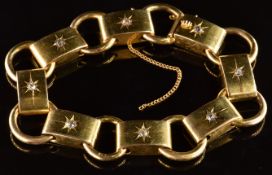 Victorian yellow metal bracelet made up of circular and oval links set with diamonds in star