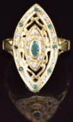 An 18ct gold ring set with emeralds and paste in a marquise setting (one emerald missing), 6.4g,