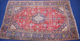 Large Persian rug with geometric borders on a wine ground, 326 x 193cm