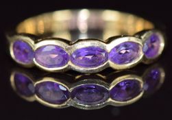 An 18ct gold ring set with five oval cut amethyst, 3.4g, size N/O