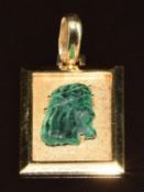 A 14k gold pendant set with an emerald cut to resemble a man or Jesus, 6.8g, 3.5 x 2cm