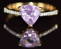 An 18k gold ring set with a trilliant cut Patroke kunzite of approximately 1.4ct, with diamond