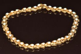 A c1900 18ct gold necklace set with oval opal cabochons, in original Joseph Heming & Co box, 28.