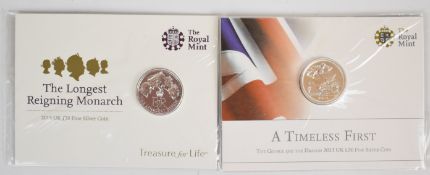 Two Royal Mint £20 fine silver coins comprising 'The Longest Reigning Monarch' and 'George and the