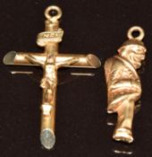 An 18ct gold crucifix pendant and an 18ct gold charm in the form of a man, 2.1g
