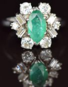 An 18ct white gold ring set with a marquise cut emerald of approximately 1ct surrounded by round and