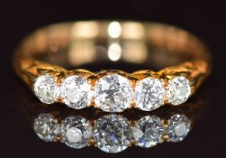 An 18ct gold ring set with five graduated old cut diamonds, the centre diamond approximately 0.24ct,