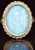 A 9ct gold ring set with a synthetic opal, 5.3g, size S