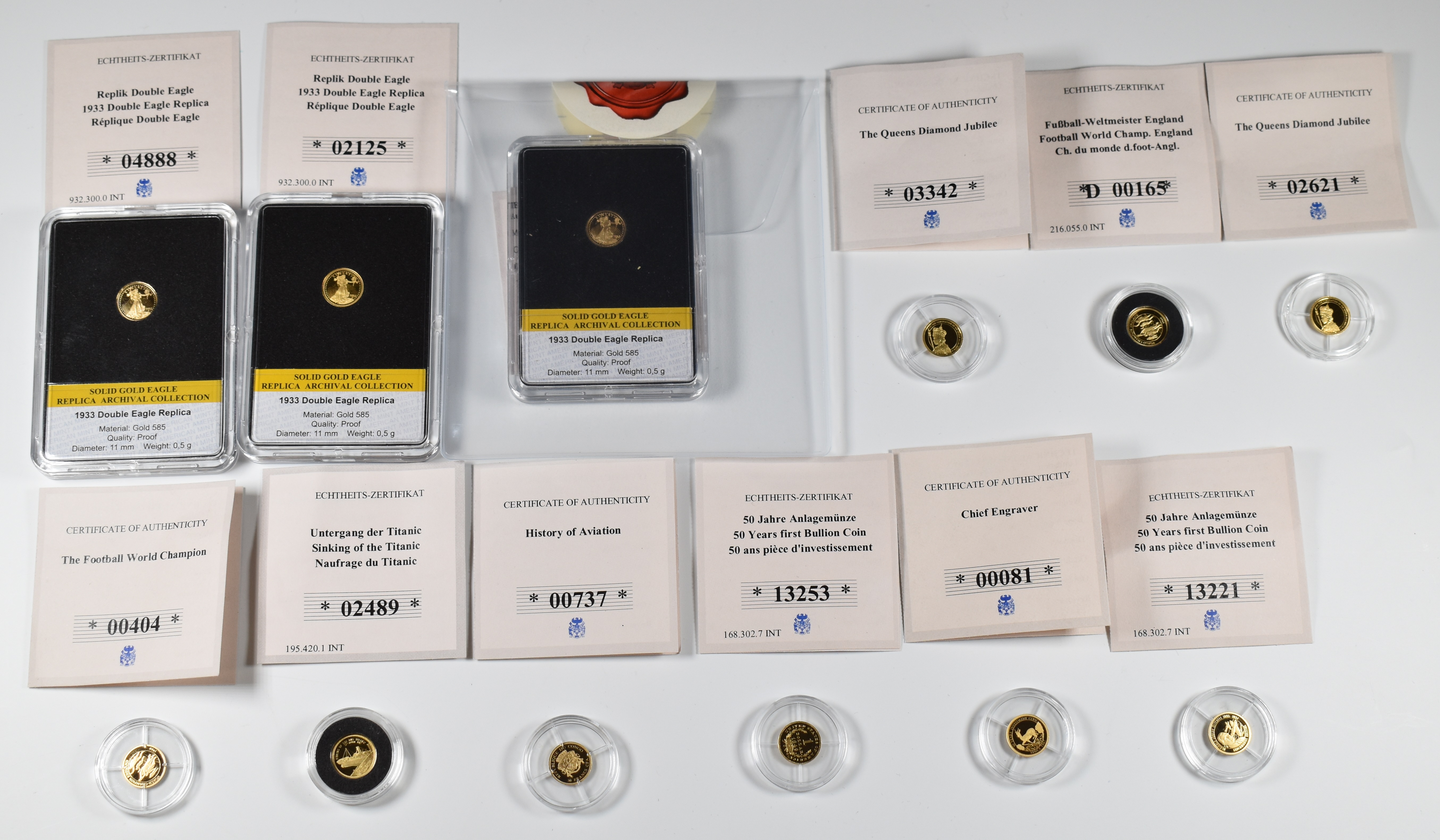 Twelve 0.585 miniature gold coins, each 0.5g, all with certificates