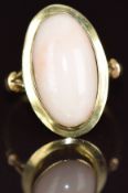 A 9ct gold ring set with a coral cabochon, 3.6g, size N