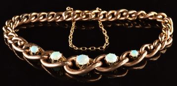 A c1900 9ct rose gold curb link bracelet set with five round cut opal cabochons, 10.3g, 18cm