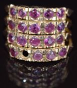 A 9ct gold ring made up of four rings each set with rubies (one missing), 4.1g, size K