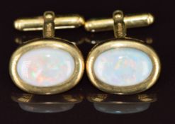 A pair of 9ct gold cufflinks each set with an opal, 6g