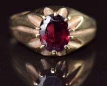 A 9ct gold ring set with an oval garnet, 3.3g, size S