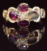 Victorian 9ct gold ring set with foiled garnets (one missing) and a pearl with scrolling detail to