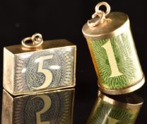 Two 9ct gold charms, one set with a one pound note the other a 5 pound note, 5.3g