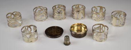 Eight Egyptian silver napkin rings together with a hallmarked silver communion pot, London 1930,