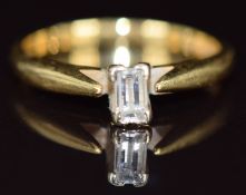 An 18ct gold ring set with an emerald cut diamond of approximately 0.2ct, 2.8g, size L